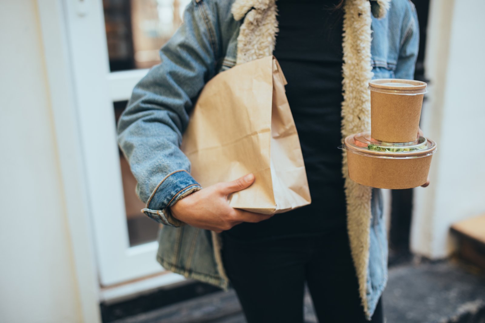 millennial-woman-holding-paper-bag-with-takeaway-food-and-coffee-to-go-.jpg